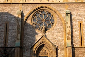 Close-up of Sacred Heart Cathedral's intricate rose window and facade in Sarajevo.
